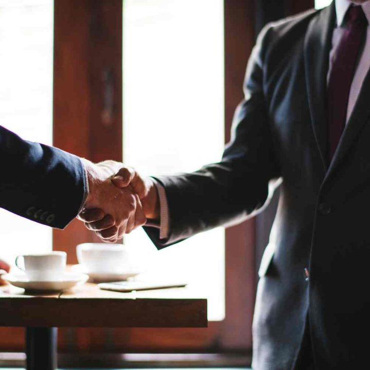 business-people-shaking-hands-meeting-room (1)